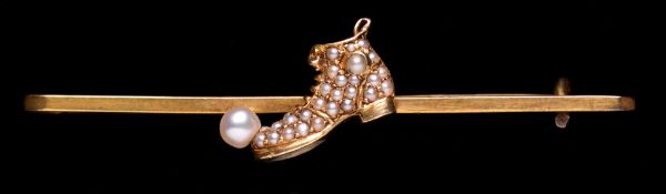 A highly unusual 14ct. gold & pearl gentlemen`s tie pin designed with a football boot and ball,