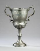 A Victorian cricket trophy, in the form of a two-handled cup in britannia metal, engraved with a