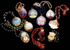 A complete run of ten gilt-metal & enamel Aintree member`s badges for the Liverpool County Stand