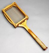 A scarce George Bussey of London "Demon Driver" wavy wedge tennis racquet with a cork inlaid
