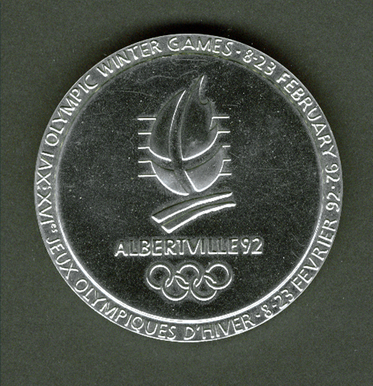 An Albertville 1992 Winter Olympic Games participation medal, designed by Renee Mayot, chrome plated