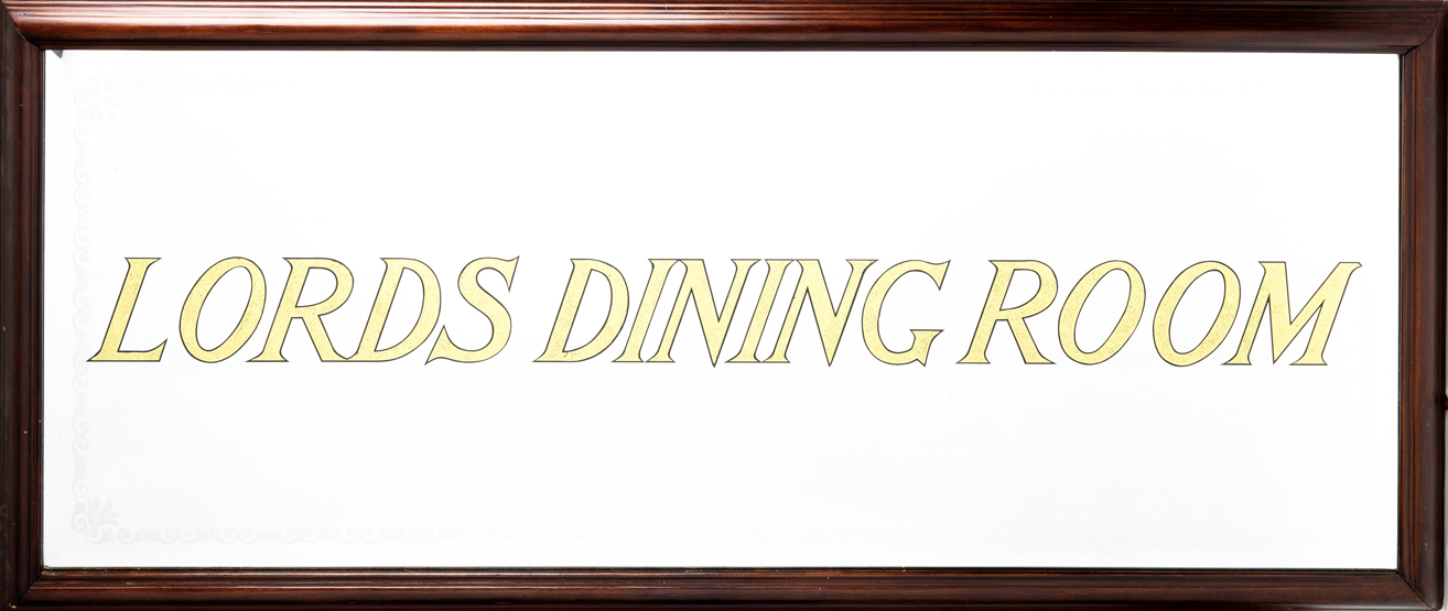 A large mirror inscribed in gold italic lettering "Lords Dining Room", foliate border, wooden frame,