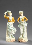 A pair of very attractive Victorian bisque lawn tennis players, in the form of a boy and girl