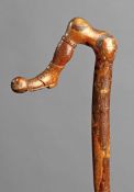 A walking stick with a handle carved as footballer`s right leg kicking the ball, circa 1910