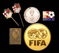 World Cup pins & medals, comprising: a 1954 badge issued to players and officials; a 1966 coin