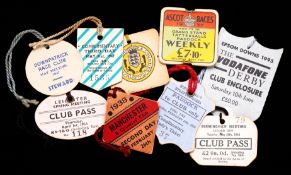 A collection of cardboard racecourse day badges, mostly modern but with a small number of earlier