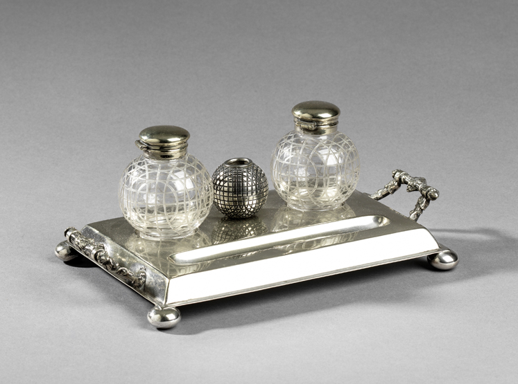 A golfing ink stand circa 1910, in electroplate with two glass ink pots with markings of a mesh