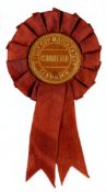 A Committee Member’s rosette from the Lindrick 1957 Ryder Cup, mounted, framed & glazed and with a