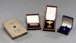 Three cased Ryder Cup pieces by Garrard of London, a gilt representation of the Ryder Cup trophy,