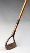 A ‘hoe’ iron by an unknown maker circa 1910, hickory shaft; together with a leather golf bag,