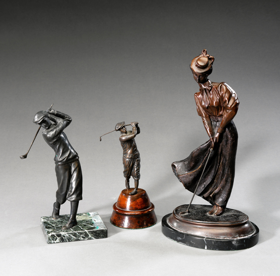 Three decorative metalware figurines, two of gentlemen golfers, the other of a lady golfer (club