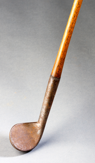 An early 19th century rut iron, with small near circular and finely knopped hosel, the hickory shaft