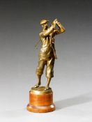 An Austrian gilt-metal figure of a golfer circa 1920, modelled in the follow through position, the