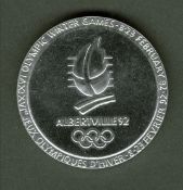 An Albertville 1992 Winter Olympic Games participation medal, designed by Renee Mayot, chrome plated