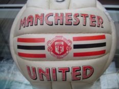A team-signed Manchester United 1980s souvenir football, the white ball with printed club name and