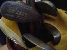 Eight hickory shafted golf clubs, including a smooth face J H Taylor mashie; sold with a leather