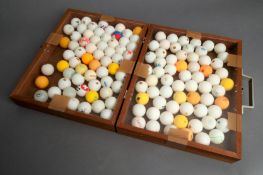 A wooden case purpose-made for the display of table tennis balls, and containing over 120 examples