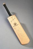 A miniature cricket bat signed by the complete Australia touring party and the England XI on the