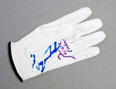 A golf glove double-signed by Tiger Woods and his former caddy Steve Williams, the white left-hand