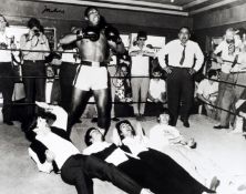 A signed print `Ali With The Beatles`, the famous image signed by Muhammad Ali, 16 by 20in.,