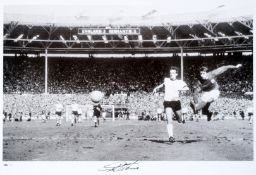 A Sir Geoff Hurst signed limited edition photographic print, b&w, portraying Hurst`s hat-trick goal,