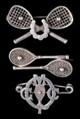 Thee small silver brooches with designs incorporating tennis racquets, one with open strings crossed