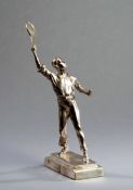 A silvered sculpture of a gentleman tennis player 1930s, the figure modelled in anticipation of