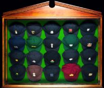 An English cricket caps display case, the glass fronted arched wooden display case containing a full