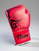 A Mike Tyson signed boxing glove, the red souvenir glove signed in black marker pen