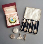 A boxed set of six golf spoons, sold together three other hallmarked silver golfing items a circular