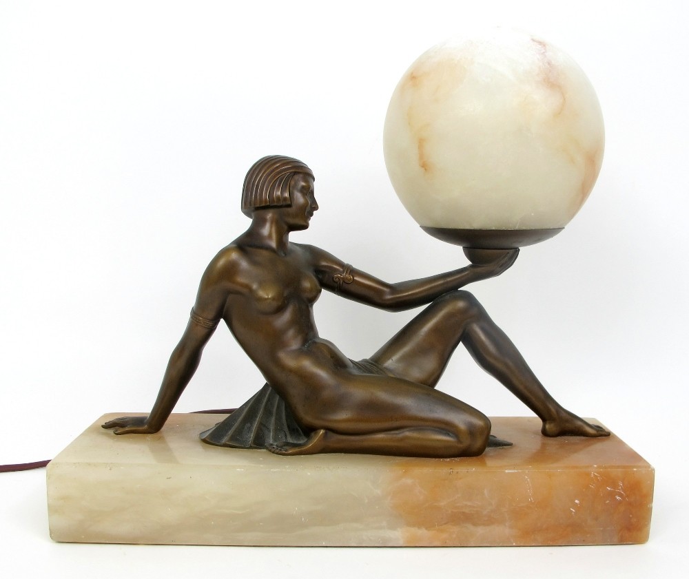 A Stylish Art Deco bronzed spelter lady lamp the reclining semi-nude figure on an alabaster base,