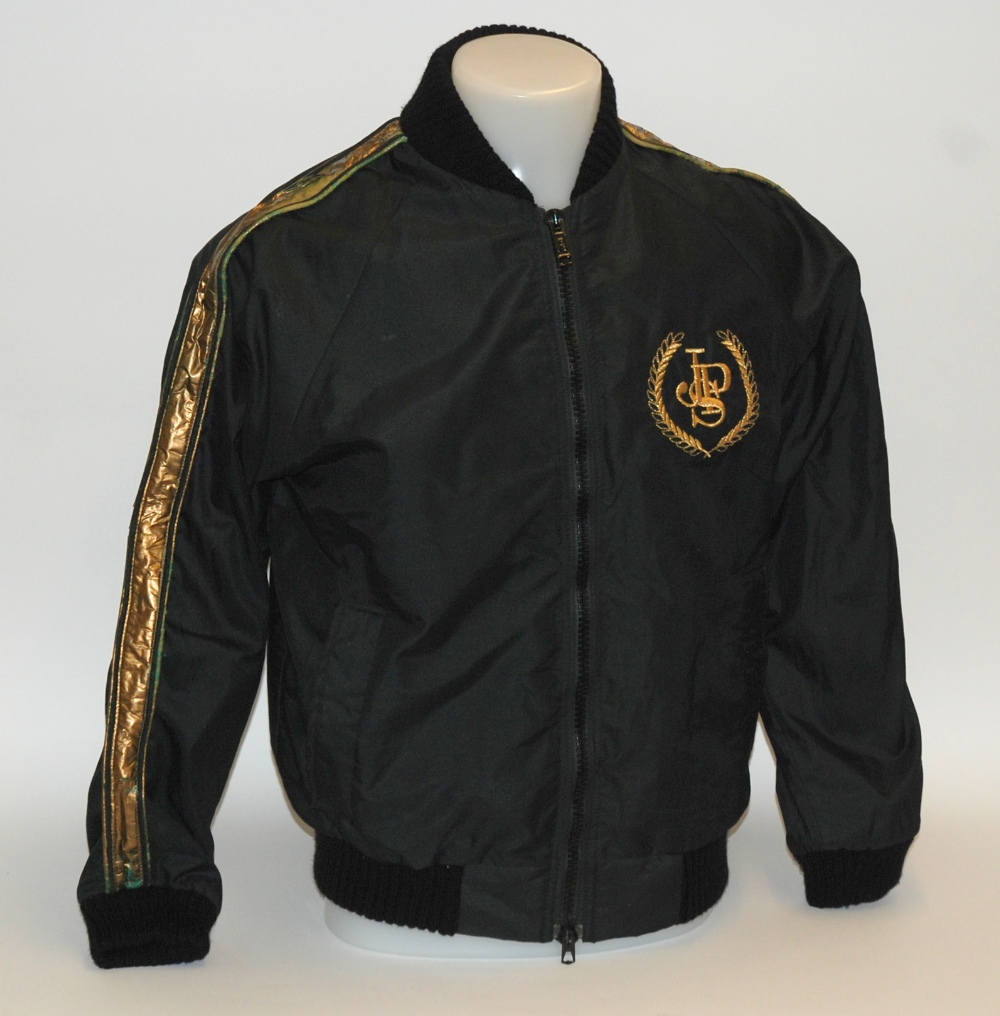 A black John Player Lotus F1 bomber jacket worn by Nigel Mansell, inscribed JSP, the reverse