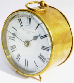 GWR brass cased Drum Clock, 4" diameter. Original enamel dial reads `JM Skarratt & Cie Paris GWR`.