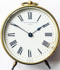 GWR brass cased Drum Clock bearing the manufacturers name `J.M. Skarratt & Co Paris` at the dial top