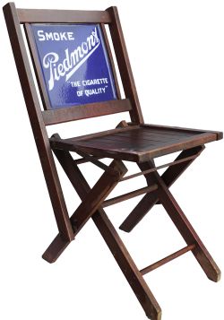 Small Folding Chair, similar to a deck chair, containing an Advertising enamel Sign as the