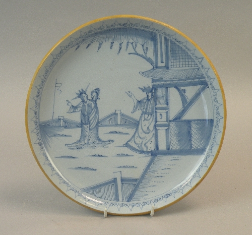 A Liverpool delftware saucer-shaped dish, circa 1760, painted and pencilled in blue with curious