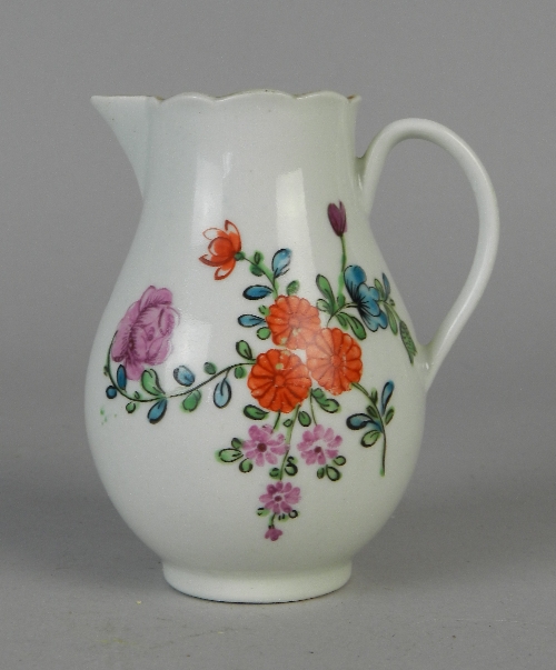 A Worcester or Caughley porcelain cream jug, circa 1765, enamelled in colours with floral sprays,