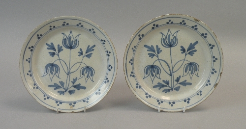 A pair of English delftware plates, probably Bristol, circa 1730, each naively painted with stylised