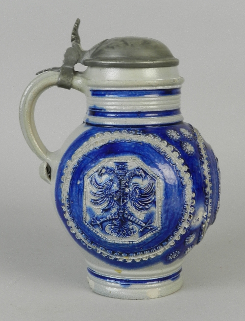 A Westerwald stoneware Krug, circa 1680, applied with three relief-moulded octagonal medallions