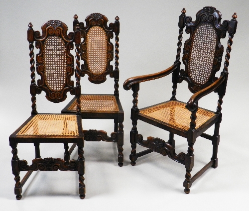 A set of eight Carolean style oak dining chairs each with a shaped top rail, over a woven cane