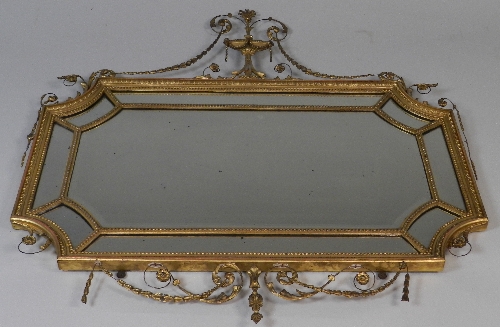 An 18th century style gesso wall mirror, the urn pediment with bell flower swags, over a segmented