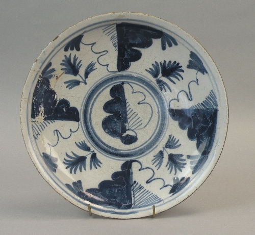 An English delftware 'oak-leaf' charger, circa 1700, painted in blue with a central stylised leaf