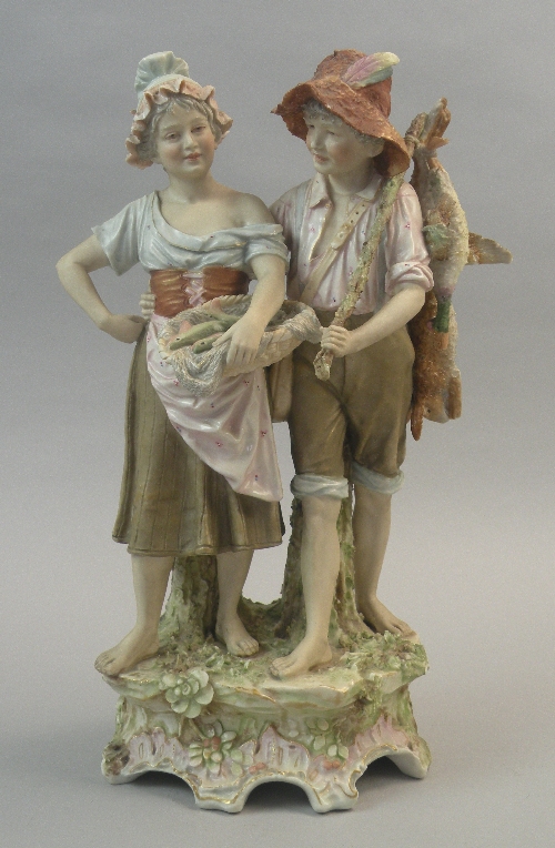 A Royal Dux standing figure group, late 19th century, modelled as a girl and boy, the former holding
