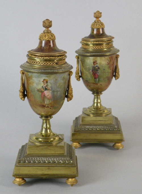 A pair of French gilt metal hand painted mantel urns, indistinctly stamped 'E.****r', each with a