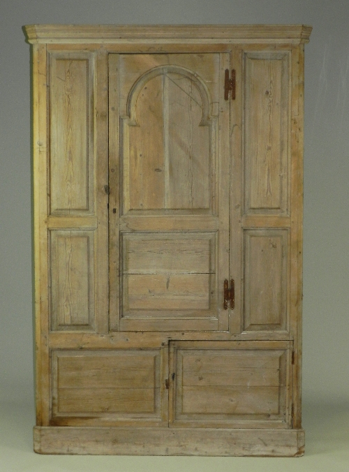 An early 19th century pine floor standing straight fronted corner cabinet, the central fielded panel