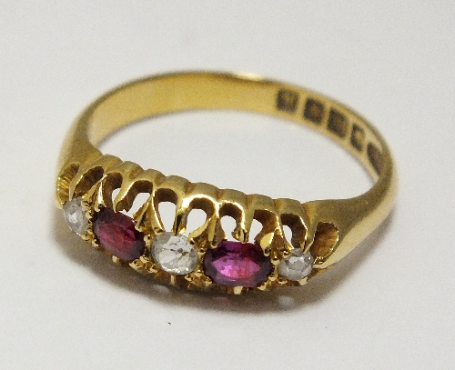 An 18ct gold five stone diamond and ruby set ring, designed as three graduated diamonds interspersed
