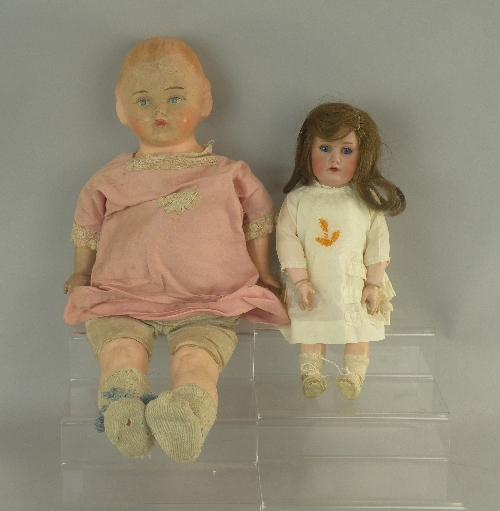 A bisque doll, circa 1920, the doll with bisque head and composition jointed body with intact