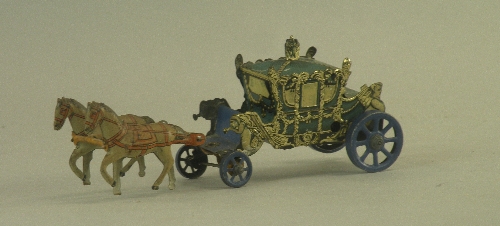A tin plate clock work model of a coach and horses, overall length 17cm the model in blue/green with