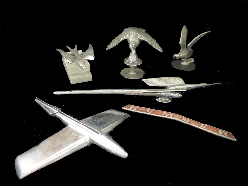 A group of six items to include a Humber Snipe bonnet mascot, a Humber badge, a stylised nickel