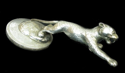 A Jaguar radiator mascot of a leaping cat mounted on a threaded radiator cap, 10.5cm in diameter,